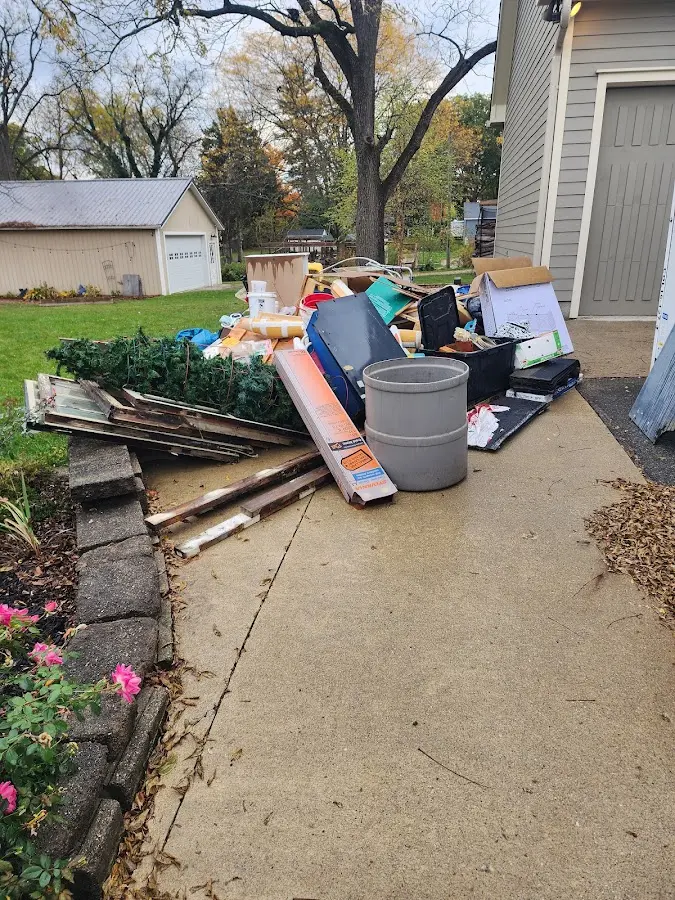 Dumpster being loaded with debris for 12 Yard Dumpster Rental in Buena Park